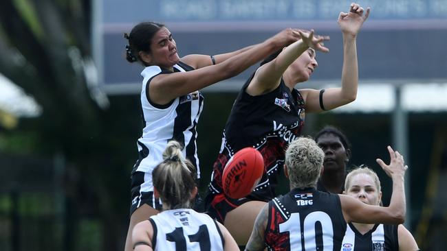 Madison Lampton flies over Bayley Valentine in round one of the Womens' NTFL 22/23 season. Picture: (A)manda Parkinson