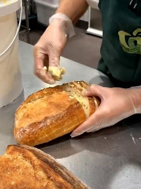 Staff stuff the bread with plenty of garlic butter. Picture: TikTok