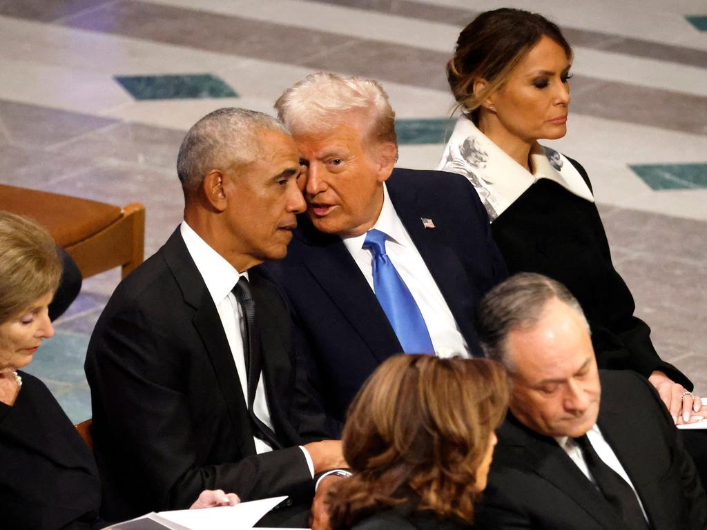 U.S. President-elect Donald Trump speaks with former U.S. President Barack Obama during the state funeral for former U.S. President Jimmy Carter with Melania sitting on the outer.