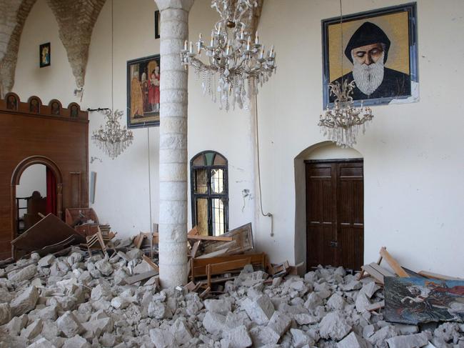 Rubble is piled up inside a church in the southern Lebanese village of Derdghaya. Picture: AFP