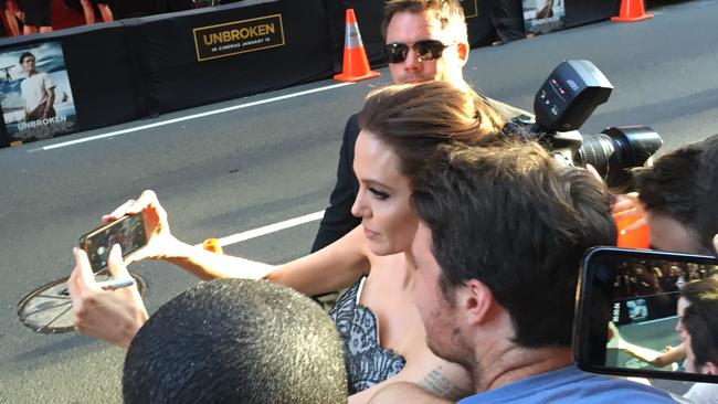 Angelina posed for selfies as traffic drove by.