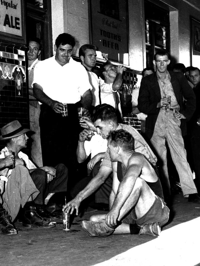 Men drinking beer outside the Balaclava Hotel in Alexandria,