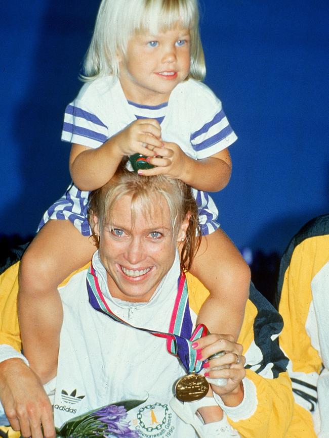 Lisa Curry celebrates with her daughter Jaimi Kenny after winning gold in the women’s 100m butterfly at the 1990 Commonwealth Games in Auckland. Picture: Getty