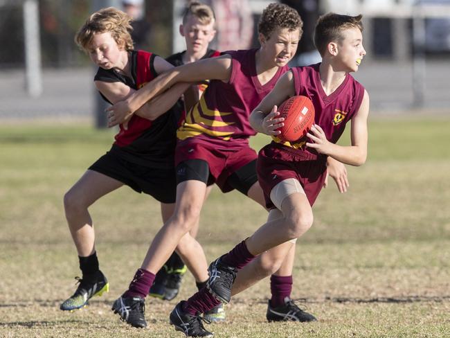 day three of the School Sport SA Sapsasa Country Football Carnival - Year 7 Division 1: Gawler (maroon) v Riverland (red/black) at West Beach , 2 June 2021. Picture Simon Cross