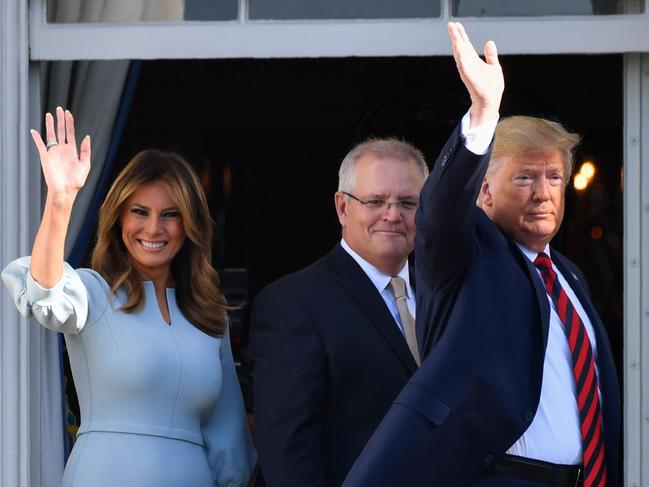 US President Donald Trump, First Lady Melania Trump, and Australian Prime Minister Scott Morrison wave from a balcony of the White House. Picture: AFP