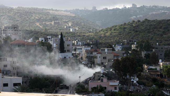 Smoke rises from a building as Israeli troops raid the occupied West Bank town of Deir al-Ghusun near Tulkarem on May 4. Picture: AFP