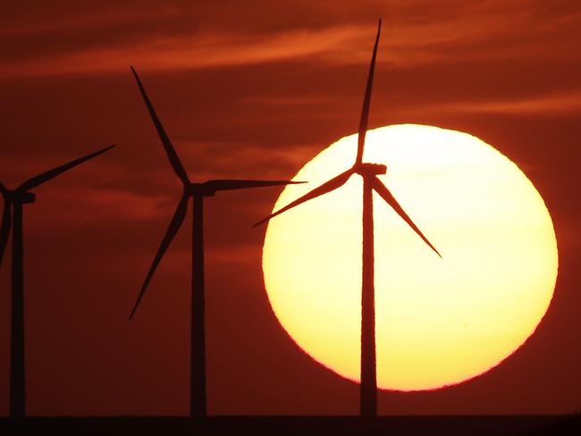 FILE - In this Aug. 23, 2013 file photo, wind turbines are silhouetted by the setting sun as they produce electricity near Beaumont, Kan. Energy independence has been a goal of every president since Richard Nixon. Hillary Clinton and Donald Trump have very different ways to achieve it. How energy is produced and where it comes from affect jobs, the economy and the environment. (AP Photo/Charlie Riedel, File)