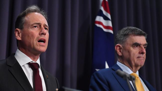 Health Minister Greg Hunt and Chief Medical Officer Brendan Murphy conceded on Monday night it was no longer possible to contain the ­disease. Picture: AAP