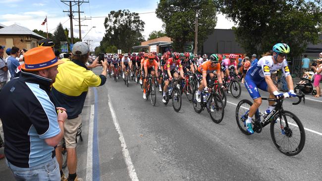 The Woodside crowds cheers on the peloton as it passes through Woodside main street. Picture: Tricia Watkinson