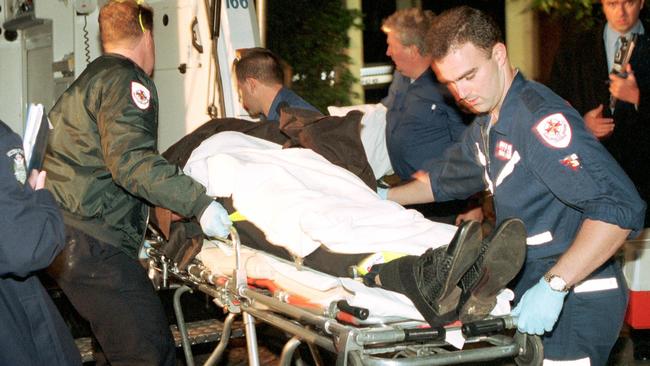 The body of Richard Mladenich is wheeled out of the Esquire Hotel in St Kilda in May 2000.