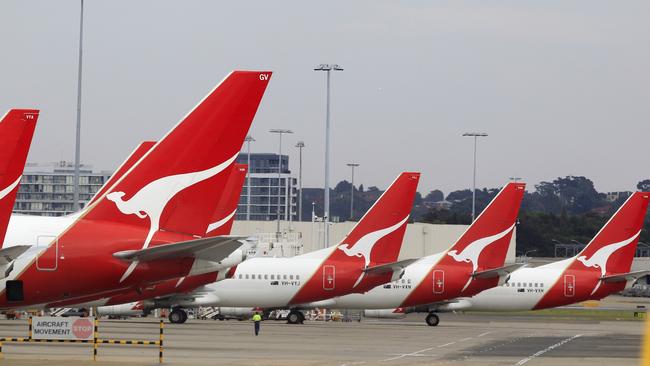 The tails of Qantas planes are lined up at Sydney Airport in Sydney, Sunday, Oct. 30, 2011. Qantas Airways grounded all of its aircraft around the world indefinitely Saturday due to ongoing strikes by its workers. (AP Photo/Rick Rycroft)