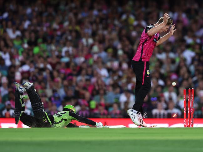 Matthew Gilkes slides home while Jack Edwards watches the ball hit the stumps. Picture: Getty Images