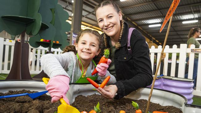 Aria Millar and mum Emily Millar unearthing carrots in the Little Backyard Farmers area at the Toowoomba Royal Show, Thursday, April 18, 2024. Picture: Kevin Farmer