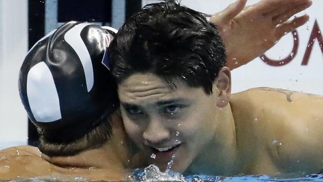 Singapore's Joseph Schooling is congratulated by Michael Phelps after winning the gold medal in the men's 100-metre butterfly. Picture: AP