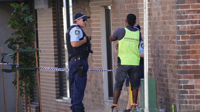 Officers speaking to one of the other workers on the site. Picture: Christian Gilles