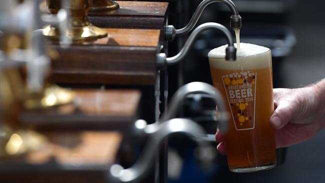 A barman pours a pint at the CAMRA (campaign for real ale) in London. Picture: GETTY IMAGES