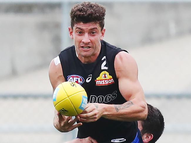 MELBOURNE, AUSTRALIA - FEBRUARY 20: Tom Liberatore of the Bulldogs looks upfield whilst being tackled during the Western Bulldogs Intra-club match session at Whitten Oval on February 20, 2019 in Melbourne, Australia. (Photo by Michael Dodge/Getty Images)