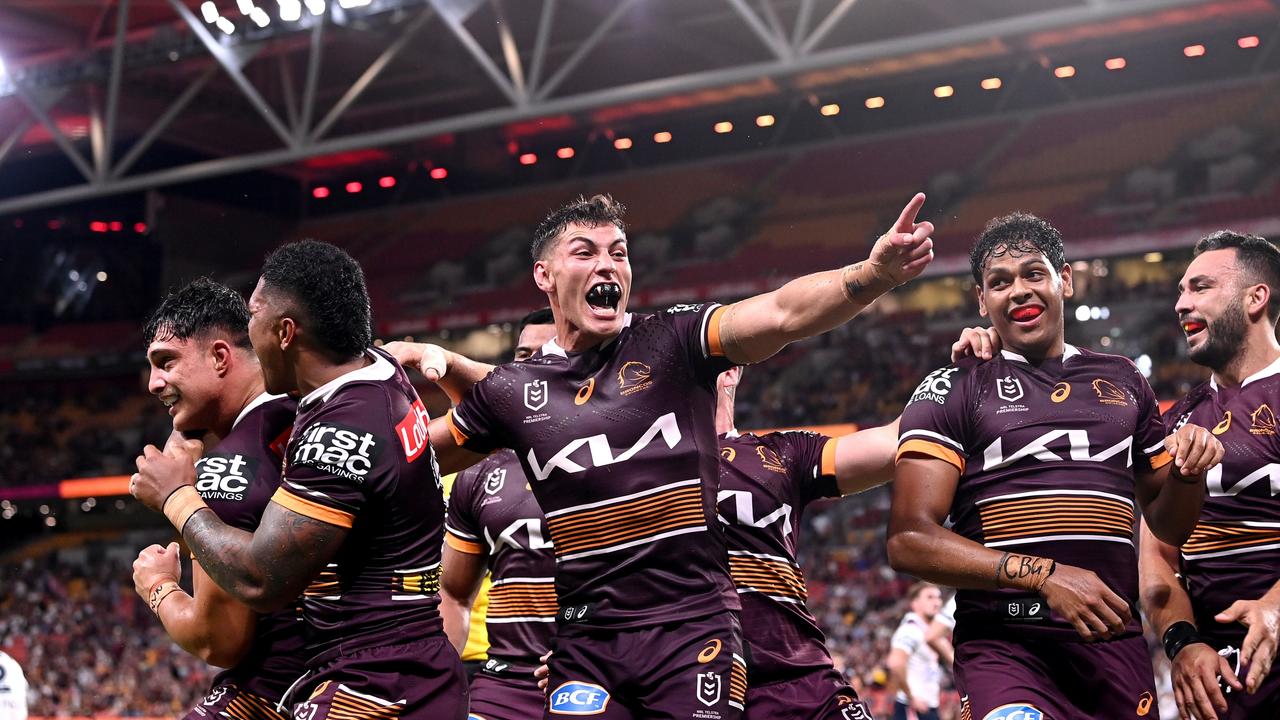 Kotoni Staggs of the Broncos is congratulated by teammates after scoring a try at Suncorp on Friday night. Picture: Bradley Kanaris/Getty Images