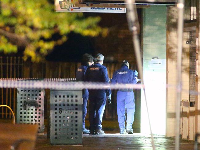 Forensics officers look for clues to the fatal stabbing. Photo: Patrick Herve