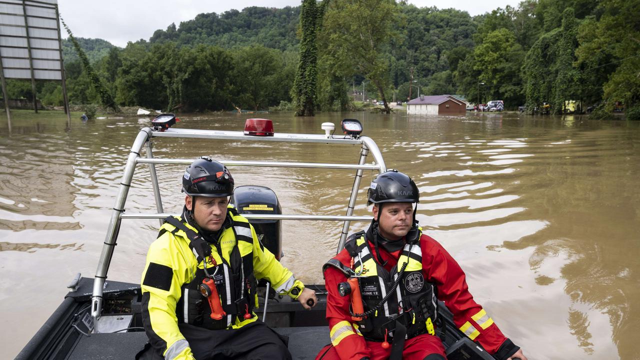 Lexington Firefighters Jeremey Miller and Captain Scott Butler on a rescue mission in Troublesome Creek to save people that have been stranded for days. Picture: AFP