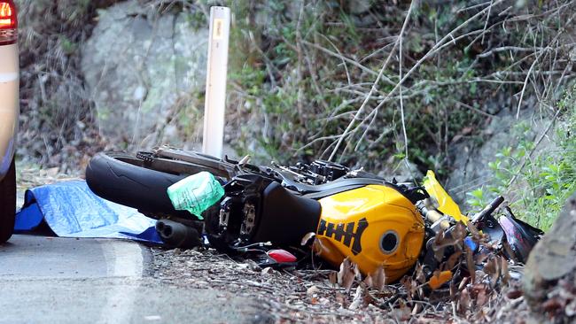 A male motorcyclist lay dead under a blue tarp this afternoon after he failed to navigate a corner on the decent of Springbrook Road, Springbrook. Picture: Richard Gosling