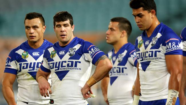 Bulldogs players looking dejected after a Cowboys try.