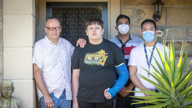 Chad, with stepfather Stjepan, and disability carers Lucky and Male. Picture: Emma Brasier.