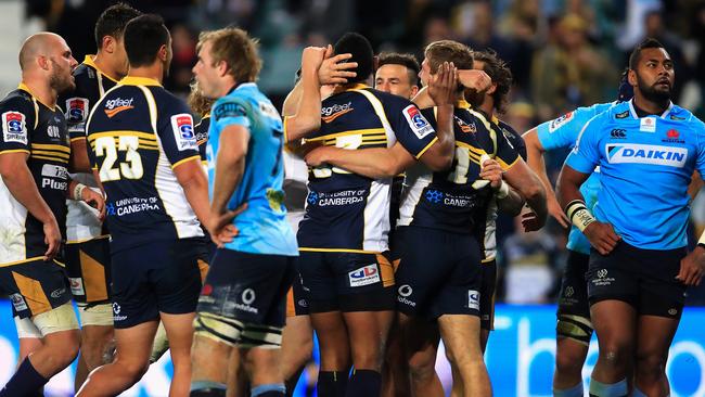 Brumbies players celebrate a try on Saturday night.