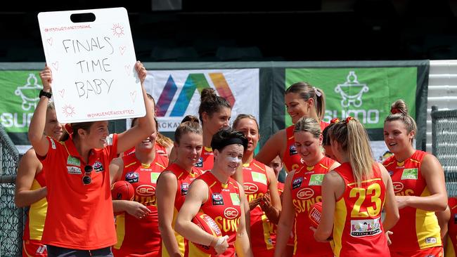 Suns players enter the field before the start of play during the AFLW semi final 4 match between the Fremantle Dockers and Gold Coast Suns at Fremantle Oval in Perth, Saturday, March 21, 2020. (AAP Image/Richard Wainwright) \