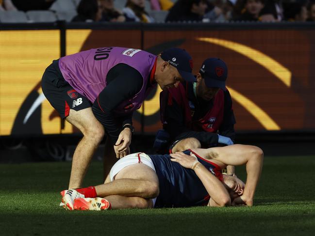 Steven May of the Demons is helped by trainer's after a heavy collision. (Photo by Darrian Traynor/Getty Images)