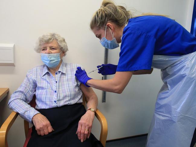 Nurse Practitioner Terri Welch (right) administers a dose of the Pfizer-BioNTech COVID-19 vaccine to a patient in northern England. Picture: Lindsey Parnaby/AFP