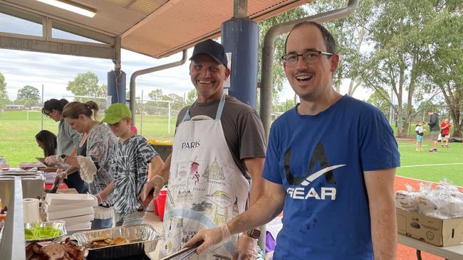 Robert Medved and Tim Dabinett keep the snags sizzling at Toongabbie Public School.