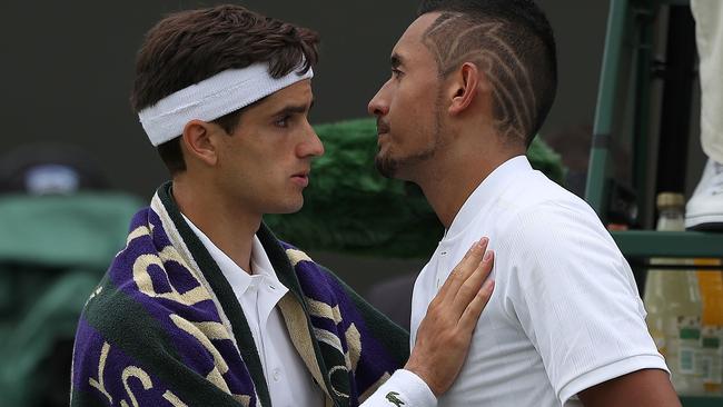 Nick Kyrgios gets a consoling pat from Pierre-Hugues Herbert.