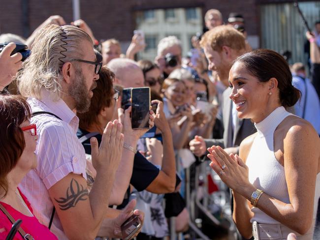 The Duchess of Sussex is greeted by wellwishers outside the town hall during the Invictus Games in Dusseldorf. Picture: Getty Images.