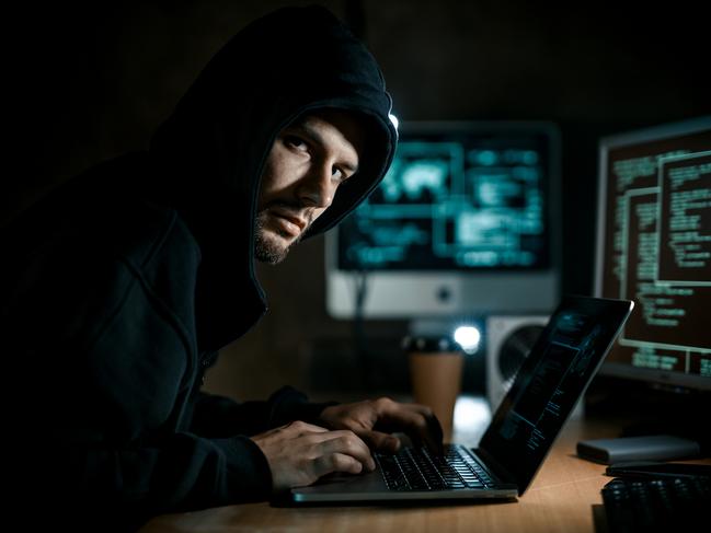 Hacker working on computer. Cyber crime concept. Scam, scammer generic.