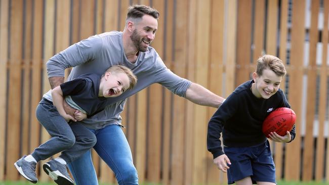 Andrew Walker with his sons Cody, 9 and Arli, 5 when they were younger. Now both could be on their way to the AFL. Picture: Alex Coppel.