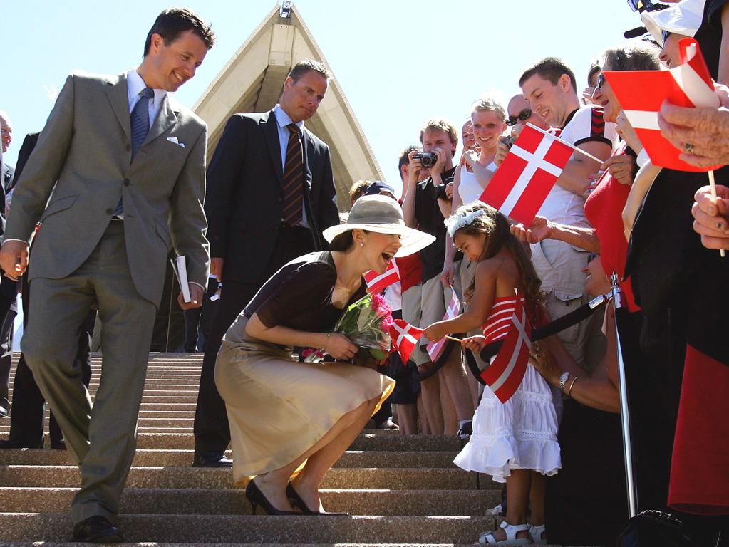 Princess Mary greets four-year-old Mia Formica as huge crowds turn out to for their first visit to Australia as a married couple. Picture: David Gray