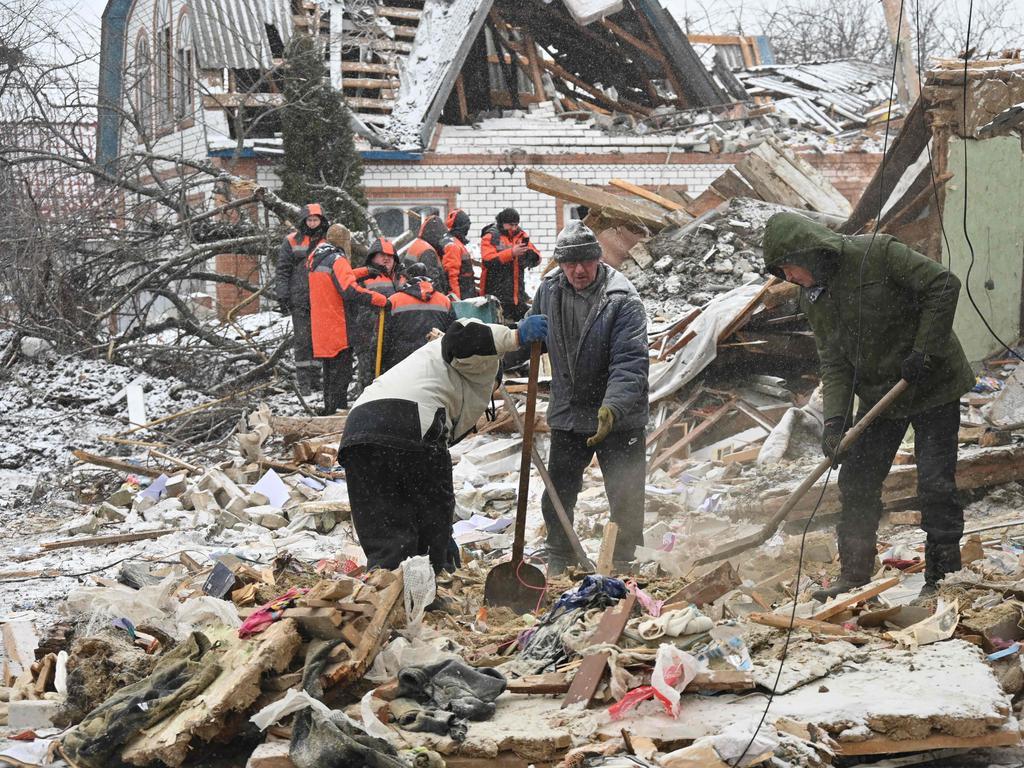 Rescuers and local residents clear debris following Russian strikes, in Zmiiv, Kharkiv region, on January 8, 2024, amid the Russian invasion of Ukraine. Picture: AFP