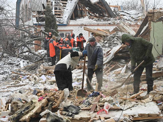 Rescuers and local residents clear debris following Russian strikes, in Zmiiv, Kharkiv region, on January 8, 2024, amid the Russian invasion of Ukraine. Picture: AFP