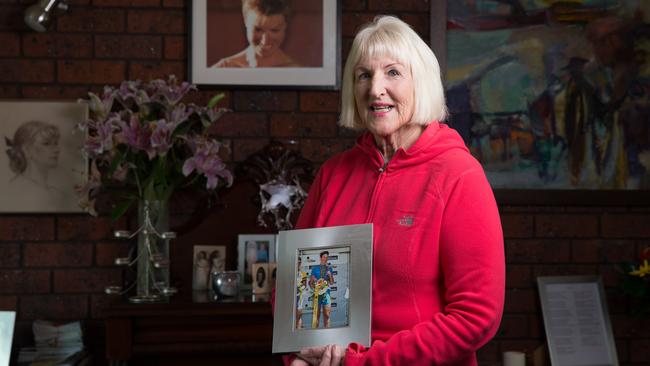 Mother of the late Amy Gillett, Mary Safe, pictured at home holding a picture of Amy.