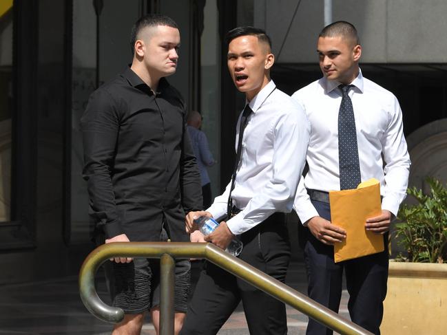 Ammon Kingi (left), with Liam Vasin Dilworth (20) and Sean Lim (20) after the trio appeared in the Downing Centre Local Court today.