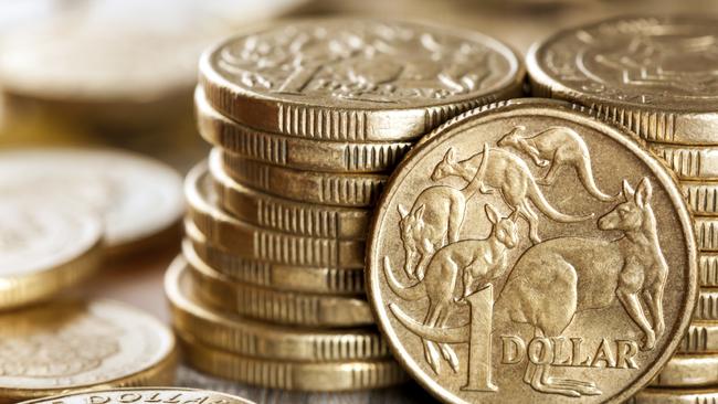 Stacks of Australian one dollar coins. Focus on front coin.