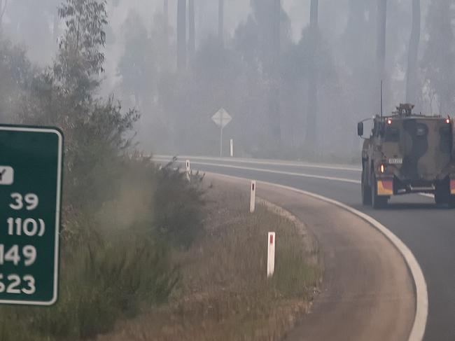 Australian Defence Force armoured vehicle is seen on the Princes Highway bringing supplies to communities cut off by bushfires. Picture: Getty Images