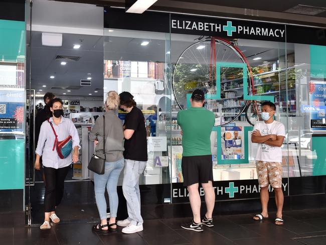 People line up outside Elizabeth Pharmacy in Melbourne’s CBD, to stock up on RATs. Picture: Nicki Connolly