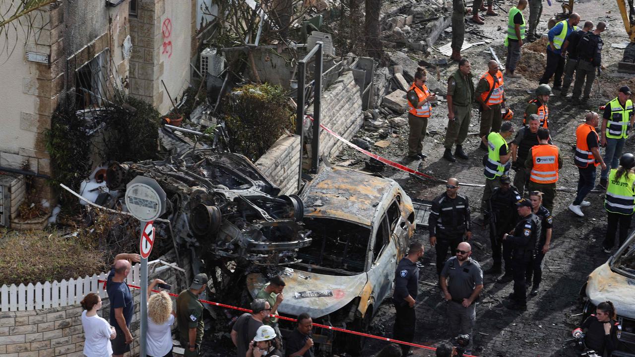 Residents watch as first responders and Israeli security forces gather in Kiryat Bialik in the Haifa district of Israel, after a reported strike by Hezbollah. Picture: Jack Guez/AFP