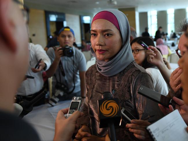 Intan Maizura Othman, a relative of passengers on missing Malaysia Airlines flight MH370, speaks to journalists after being presented with the final investigation report. Picture: AFP