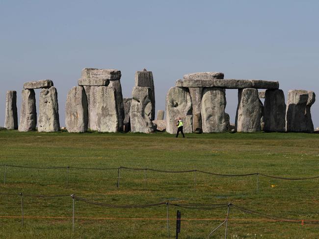 Security guards patrol the prehistoric monument at Stonehenge in southern England, on April 26, 2020, closed during the national lockdown due to the novel coronavirus COVID-19 pandemic. - Britain's health ministry on Saturday said 813 more people had died after testing positive for COVID-19 in hospital, taking the death toll to 20,319. (Photo by Adrian DENNIS / AFP)