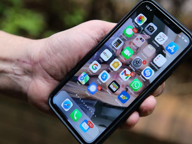 SYDNEY, AUSTRALIA - Newswire Photos - September 27, 2022:A general view of a man holding a smart phone in the wake of the Optus scandal. Picture: NCA Newswire/ Gaye Gerard