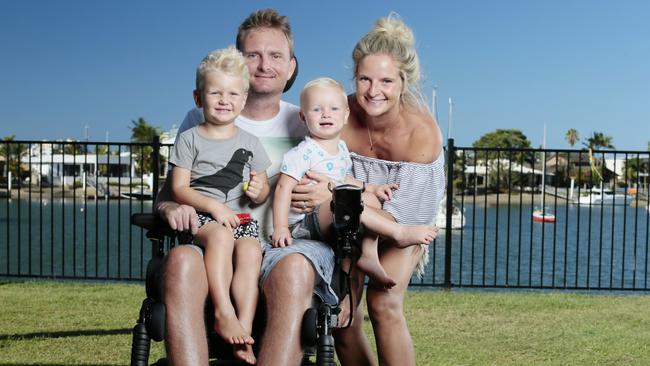 Rob Croll, who was paralysed while surfing at Kirra a year ago today, with wife Katie and sons Rafe and Bowie. Photo: Lachie Millard