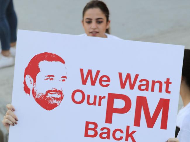 A supporter of Lebanon's former prime minister Saad Hariri holds up a placard demanding his return from Saudi Arabia. Picture: AFP / ANWAR AMRO